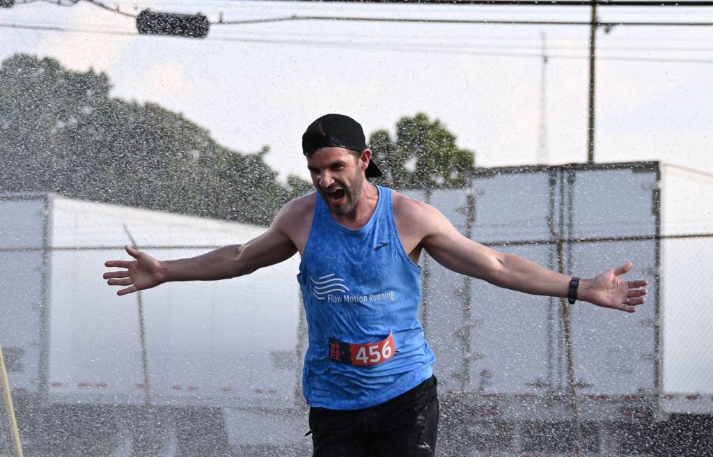 Coach Mike running through a Sprinkler (Thanks Noda 5k)