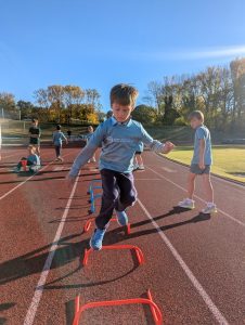 Athlete jumping over hurdles